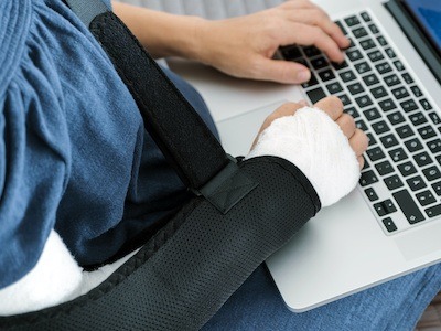 man using computer for social security disability and advocate services by disability apply houston texas
